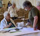 Jennifer, our programme secretary helping a member book a workshop