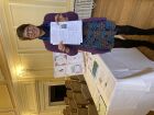 Committee member, Tracy, giving out newsletters with a smile